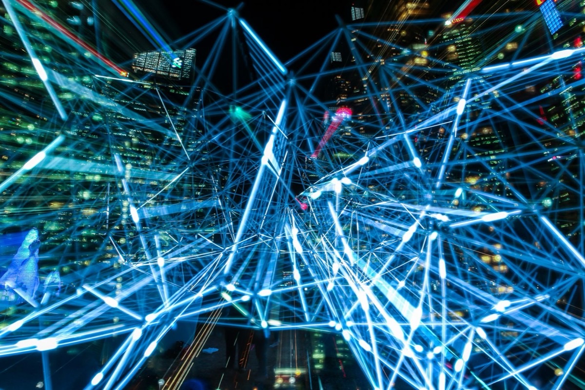 An abstract network of glowing blue connections over a city