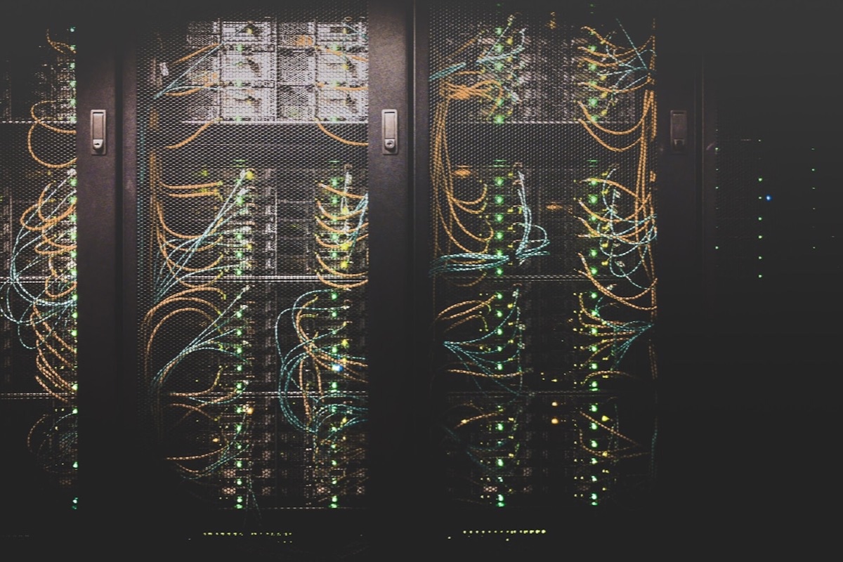 A data center with illuminated server racks and cabling